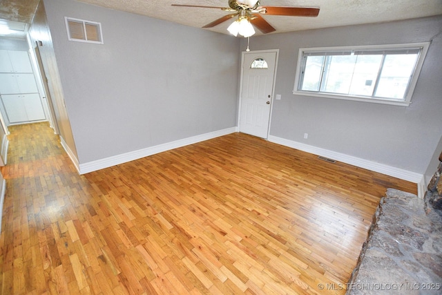 1107 Hillcrest Ave, Tahlequah, OK 74464 - unfurnished room with light wood-style flooring, a ceiling fan, and a textured ceiling