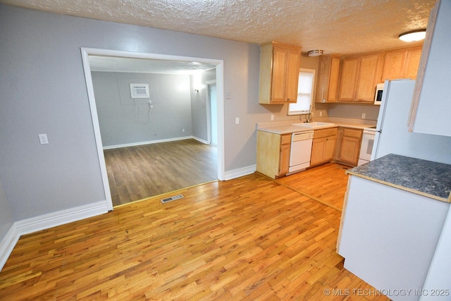 1107 Hillcrest Ave, Tahlequah, OK 74464 - kitchen with white appliances, light wood finished floors, a textured ceiling, and light brown cabinetry