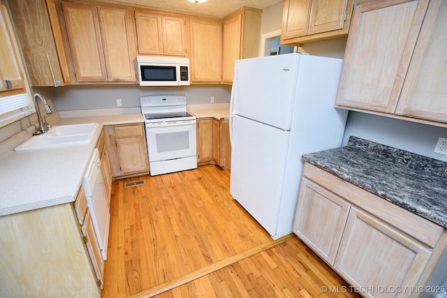 1107 Hillcrest Ave, Tahlequah, OK 74464 - kitchen with white appliances, light wood finished floors, and light brown cabinets