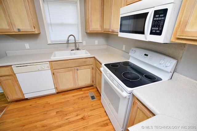 1107 Hillcrest Ave, Tahlequah, OK 74464 - kitchen with white appliances, light brown cabinets, light wood-style flooring, and light countertops