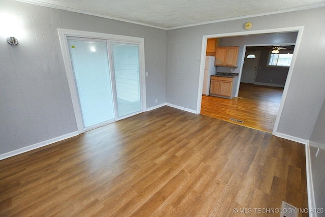 1107 Hillcrest Ave, Tahlequah, OK 74464 - unfurnished living room with light wood-type flooring, crown molding, and a ceiling fan