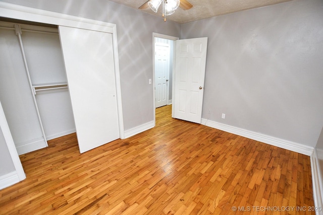 1107 Hillcrest Ave, Tahlequah, OK 74464 - unfurnished bedroom featuring light wood-style flooring, a closet, and a ceiling fan