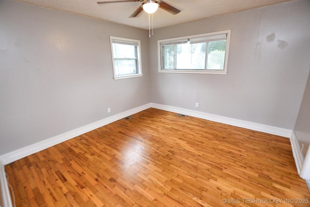 1107 Hillcrest Ave, Tahlequah, OK 74464 - empty room with a ceiling fan, wood finished floors, and plenty of natural light