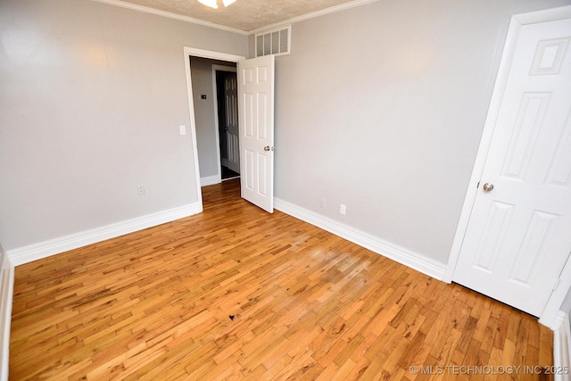 1107 Hillcrest Ave, Tahlequah, OK 74464 - spare room with light wood-style flooring and ornamental molding