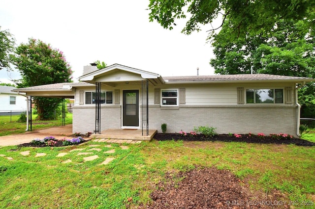 1107 Hillcrest Ave, Tahlequah, OK 74464 - ranch-style home with brick siding, an attached carport, a chimney, and concrete driveway