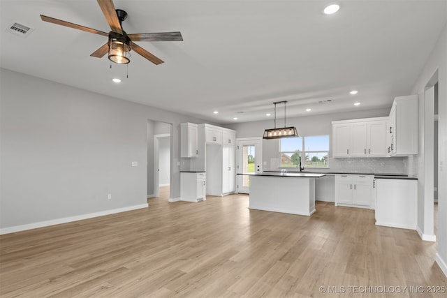 59 Michael, Durant, OK 74730 - kitchen with dark countertops, recessed lighting, a ceiling fan, light wood finished floors, and white cabinets