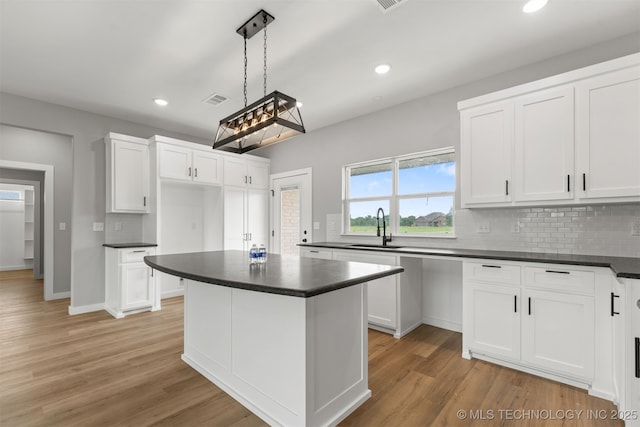 59 Michael, Durant, OK 74730 - kitchen with dark countertops, backsplash, white cabinetry, and recessed lighting