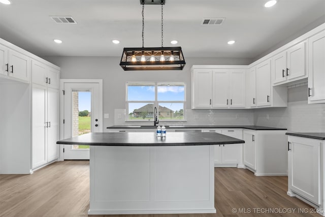 59 Michael, Durant, OK 74730 - kitchen featuring dark countertops, decorative backsplash, light wood-type flooring, plenty of natural light, and recessed lighting