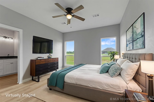 59 Michael, Durant, OK 74730 - bedroom with light wood-style floors, ensuite bathroom, and a ceiling fan