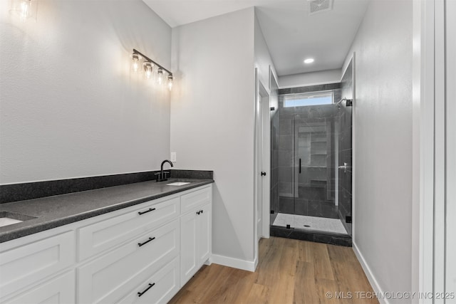59 Michael, Durant, OK 74730 - full bath with double vanity, a shower stall, and wood finished floors