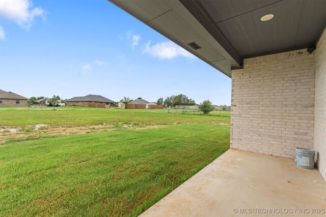 59 Michael, Durant, OK 74730 - view of green lawn with a patio area