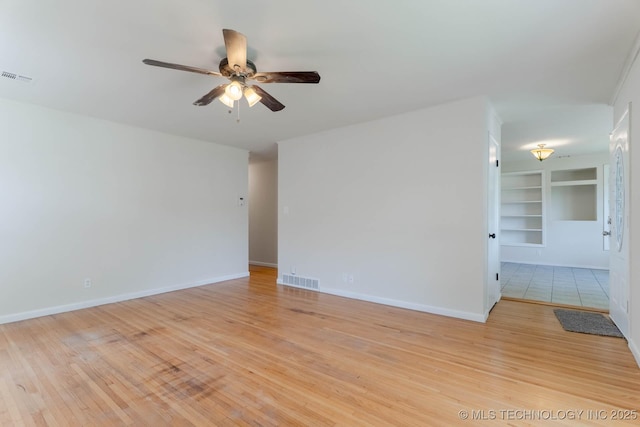1632 E 55th Pl, Tulsa, OK 74105 - unfurnished room with built in features, a ceiling fan, and light wood-type flooring