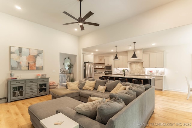 12926 S 20th Pl E, Jenks, OK 74037 - living area featuring a ceiling fan, light wood-style floors, recessed lighting, and a high ceiling