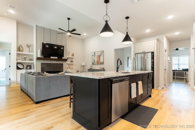 12926 S 20th Pl E, Jenks, OK 74037 - kitchen featuring dishwasher, a ceiling fan, light wood finished floors, recessed lighting, and a towering ceiling