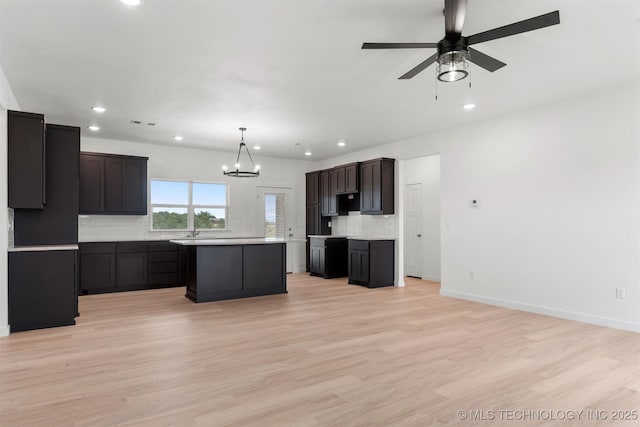 108 Michael, Calera, OK 74730 - kitchen with recessed lighting, decorative backsplash, a kitchen island, a chandelier, and light countertops