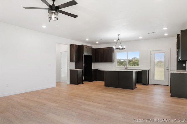 108 Michael, Calera, OK 74730 - kitchen with recessed lighting, a kitchen island, light countertops, light wood-style floors, and ceiling fan