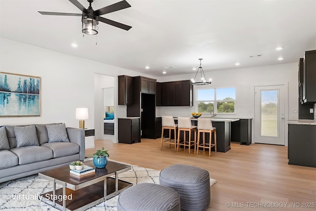 108 Michael, Calera, OK 74730 - living room with light wood-style floors, recessed lighting, a ceiling fan, and a chandelier