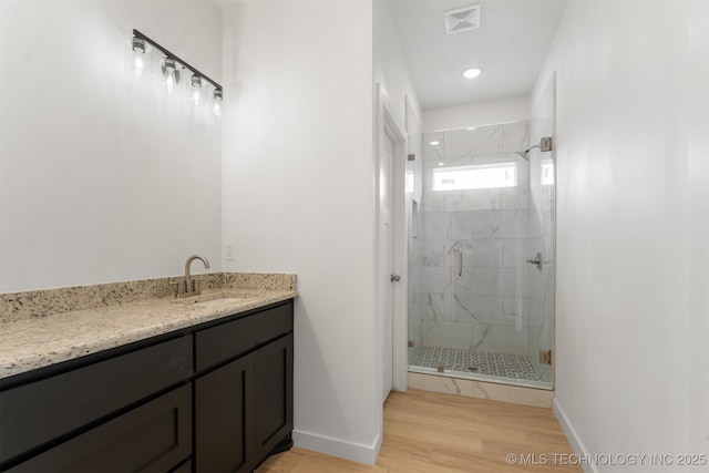 108 Michael, Calera, OK 74730 - bathroom featuring a marble finish shower, vanity, and wood finished floors