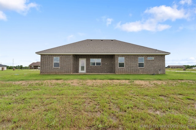 108 Michael, Calera, OK 74730 - rear view of property featuring brick siding, a yard, and roof with shingles