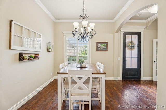 7722 N 142nd Ave E, Owasso, OK 74055 - dining area with dark wood finished floors, arched walkways, a chandelier, and ornamental molding