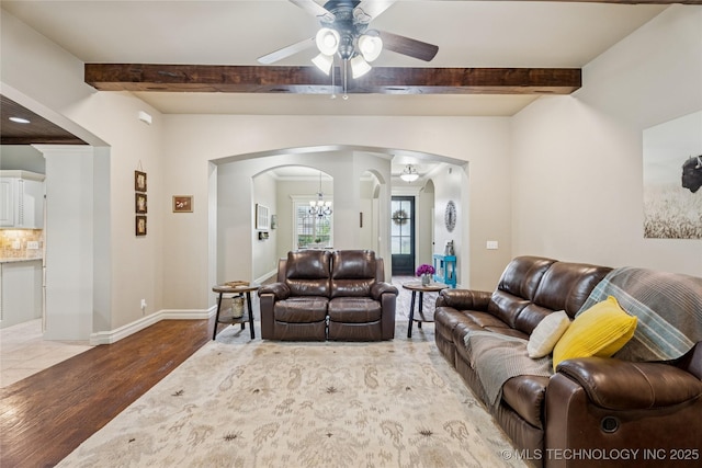 7722 N 142nd Ave E, Owasso, OK 74055 - living room with arched walkways, wood finished floors, a ceiling fan, and beam ceiling