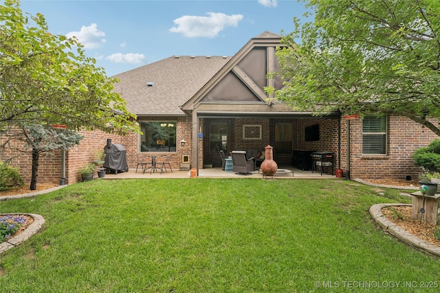 7722 N 142nd Ave E, Owasso, OK 74055 - rear view of house with a patio area, roof with shingles, brick siding, and a lawn