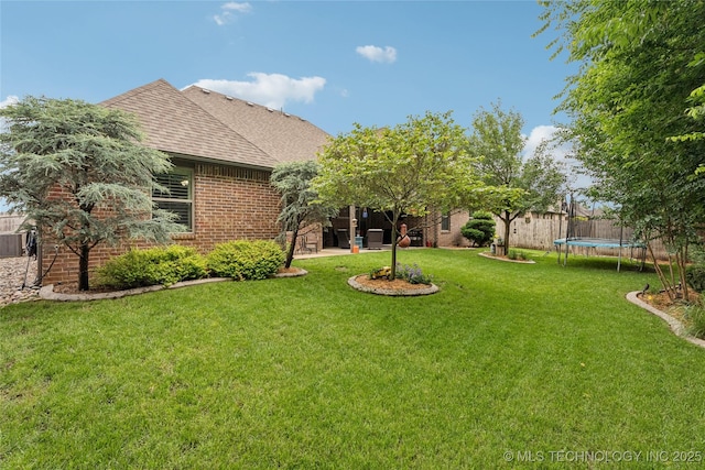 7722 N 142nd Ave E, Owasso, OK 74055 - view of yard with a trampoline and a patio area