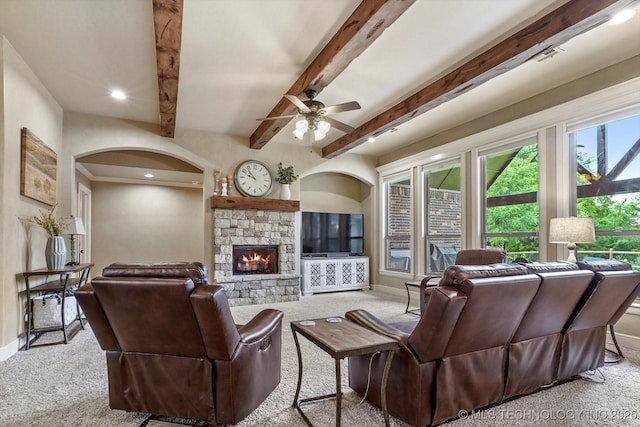 9312 N 93rd Ave E, Owasso, OK 74055 - carpeted living room with arched walkways, a fireplace, a ceiling fan, beamed ceiling, and recessed lighting