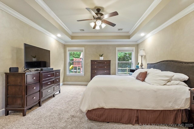 9312 N 93rd Ave E, Owasso, OK 74055 - bedroom featuring a tray ceiling, multiple windows, carpet flooring, ornamental molding, and ceiling fan