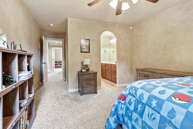 9312 N 93rd Ave E, Owasso, OK 74055 - bedroom with light carpet, arched walkways, ensuite bath, and a ceiling fan