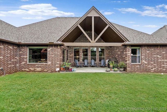 9312 N 93rd Ave E, Owasso, OK 74055 - rear view of house featuring brick siding, roof with shingles, a patio, and a yard
