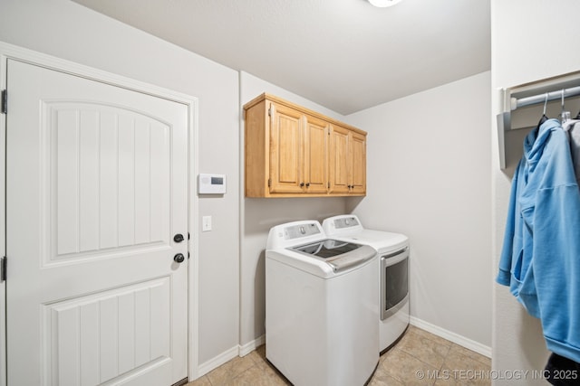5029 S 168th E Ave, Tulsa, OK 74134 - washroom featuring washer and clothes dryer, cabinet space, and light tile patterned flooring