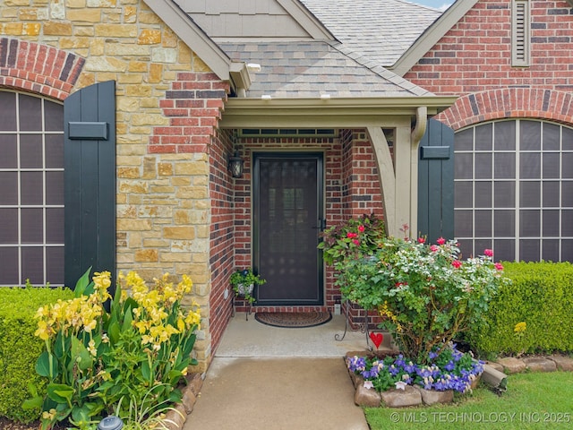 5029 S 168th E Ave, Tulsa, OK 74134 - property entrance featuring roof with shingles, brick siding, and stone siding