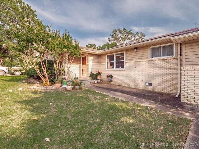 1508 E Seminole Ave, Mcalester, OK 74501 - view of front facade with brick siding, a front lawn, and crawl space