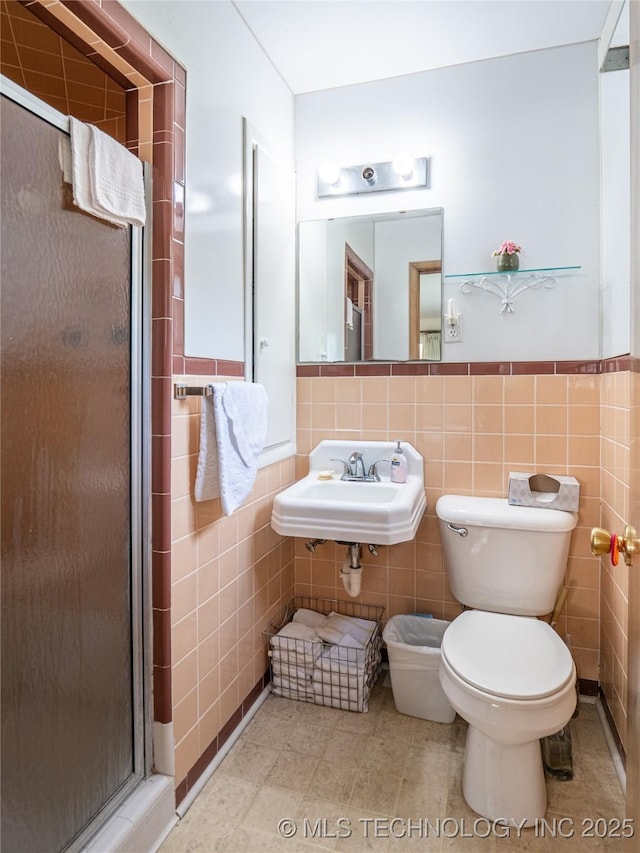 1508 E Seminole Ave, Mcalester, OK 74501 - full bathroom with a shower stall, tile walls, and a wainscoted wall