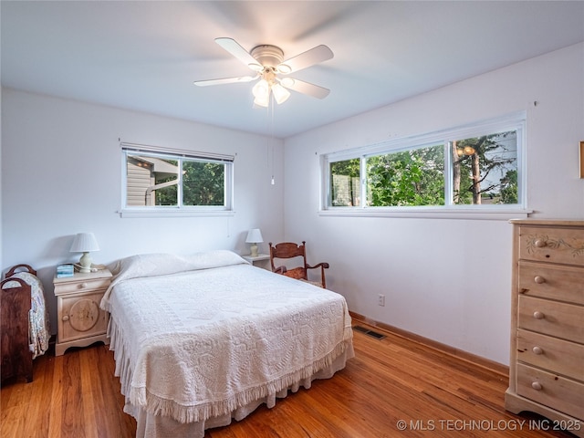 1508 E Seminole Ave, Mcalester, OK 74501 - bedroom with light wood finished floors and ceiling fan