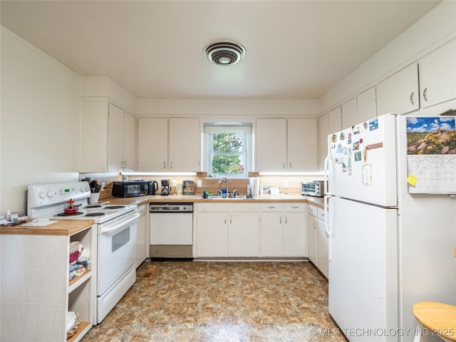 1508 E Seminole Ave, Mcalester, OK 74501 - kitchen with white appliances, light countertops, and white cabinetry