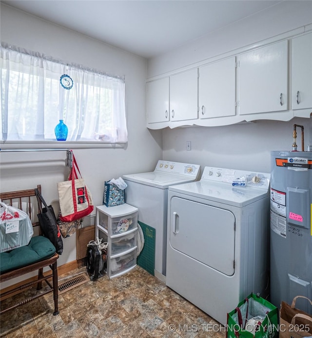 1508 E Seminole Ave, Mcalester, OK 74501 - laundry room featuring electric water heater, separate washer and dryer, stone finish floors, and cabinet space