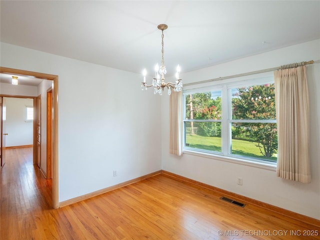 1508 E Seminole Ave, Mcalester, OK 74501 - spare room with a chandelier, light wood-type flooring, and healthy amount of natural light