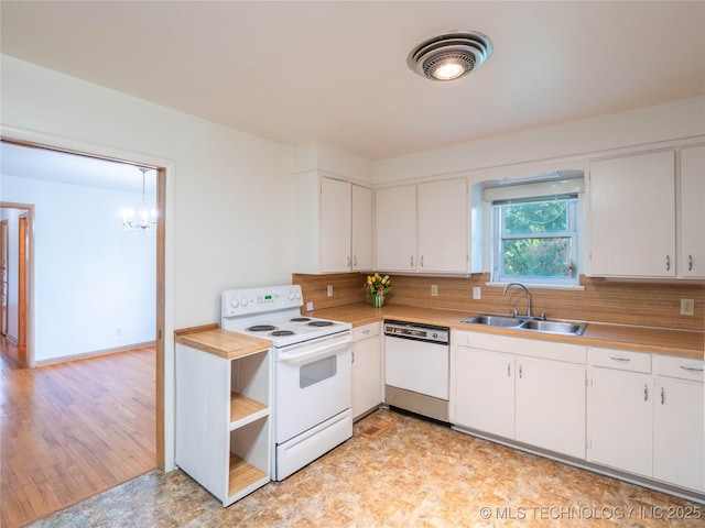 1508 E Seminole Ave, Mcalester, OK 74501 - kitchen featuring white appliances, light countertops, a chandelier, backsplash, and white cabinetry