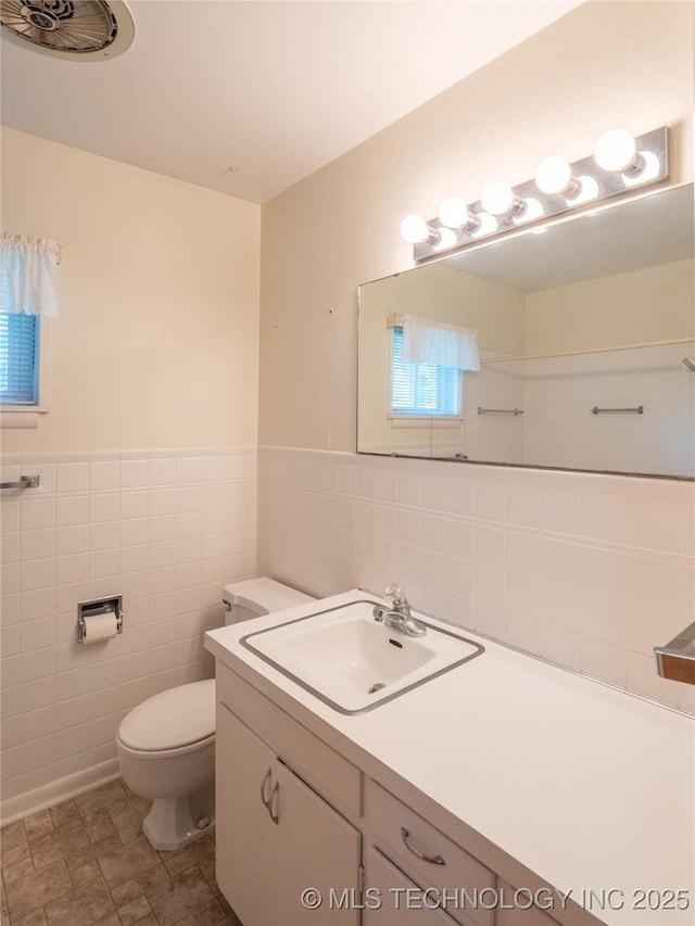 1508 E Seminole Ave, Mcalester, OK 74501 - bathroom with tile walls, vanity, and a wainscoted wall