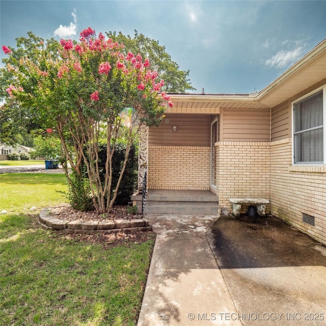 1508 E Seminole Ave, Mcalester, OK 74501 - entrance to property featuring brick siding, a lawn, and a porch