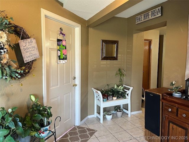 1203 NW 5th St, Stigler, OK 74462 - foyer entrance featuring light tile patterned floors and baseboards
