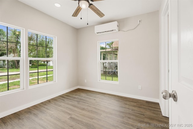 107 S Wyandotte Ave, Dewey, OK 74029 - spare room featuring a wall mounted air conditioner, plenty of natural light, a ceiling fan, wood finished floors, and recessed lighting