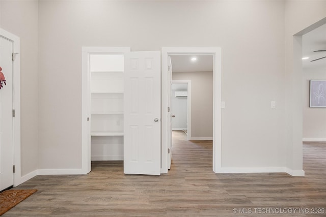107 S Wyandotte Ave, Dewey, OK 74029 - hall featuring wood finished floors, an AC wall unit, and recessed lighting