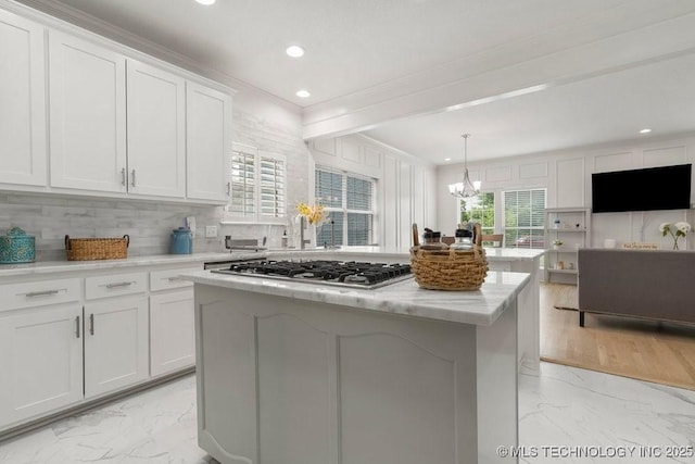 9703 S 100th E Ave, Tulsa, OK 74133 - kitchen featuring light marble finish floors, stainless steel gas stovetop, ornamental molding, a center island, and decorative backsplash