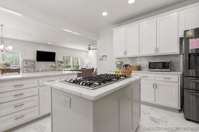 9703 S 100th E Ave, Tulsa, OK 74133 - kitchen with appliances with stainless steel finishes, light marble finish floors, recessed lighting, a center island, and white cabinets
