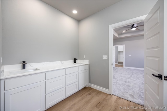 250 Maple Leaf Dr, Durant, OK 74701 - bathroom featuring wood finished floors, double vanity, recessed lighting, a ceiling fan, and a raised ceiling