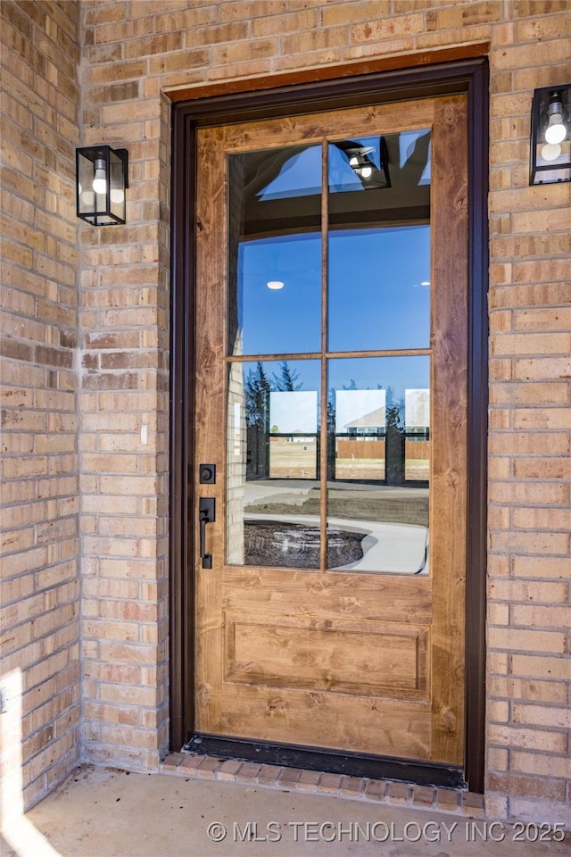 250 Maple Leaf Dr, Durant, OK 74701 - doorway to property with brick siding