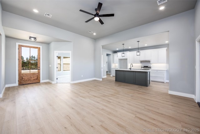 250 Maple Leaf Dr, Durant, OK 74701 - unfurnished living room featuring a ceiling fan, light wood-style floors, and recessed lighting